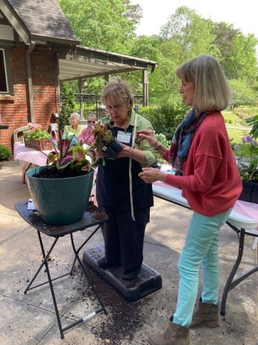 Nancy Martin demonstrating container planting with Kathy Delaney s assistance